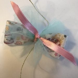 tying ribbon on front of bow