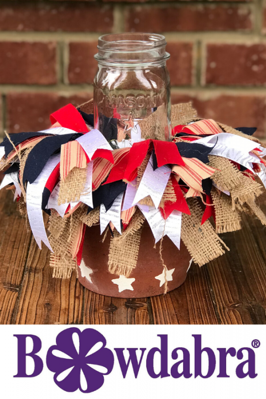 Make an easy Summer Outdoor Table Centerpiece. DIY scrappy bows add character and farmhouse flair to this easy centerpiece. #diycenterpiece #diytabledecorations #farmhouse #rustic 